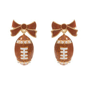 Load image into Gallery viewer, Glittery Football &amp; Bow Drop Earrings
